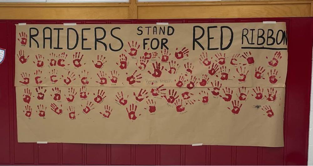 Red Ribbon Week Banner with Student handprints